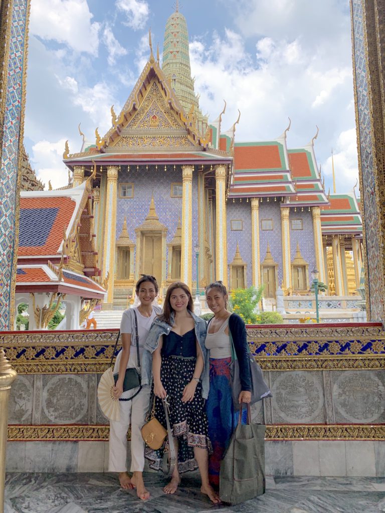 girls posing by the Grand Palace in Bangkok Thailand